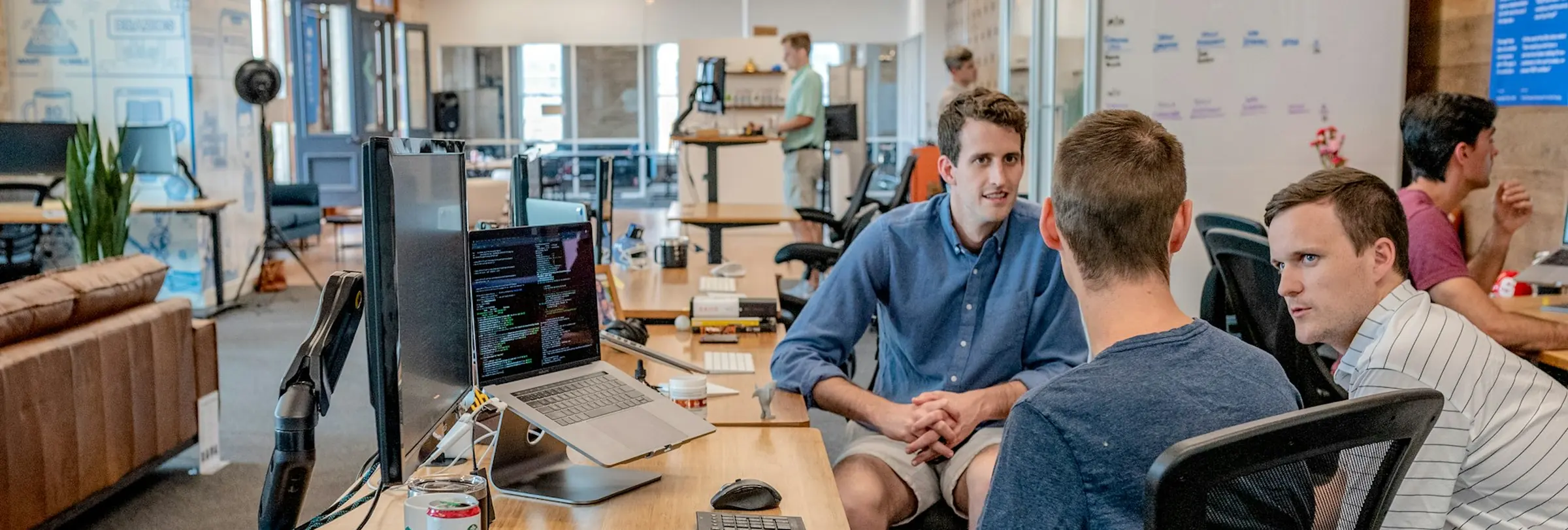 A hiring team around one desk, going through candidates together.