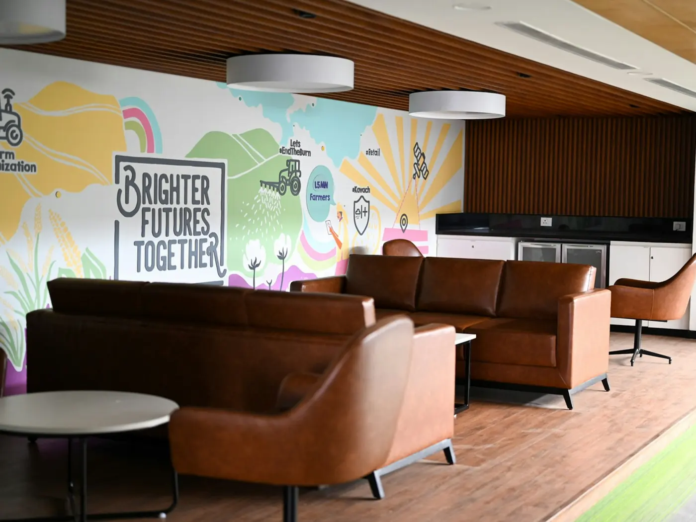 A lounge with a mural across the wall, words painted large.